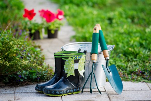 Community gardener at work in a Palmers Green front garden showing accessible pathway